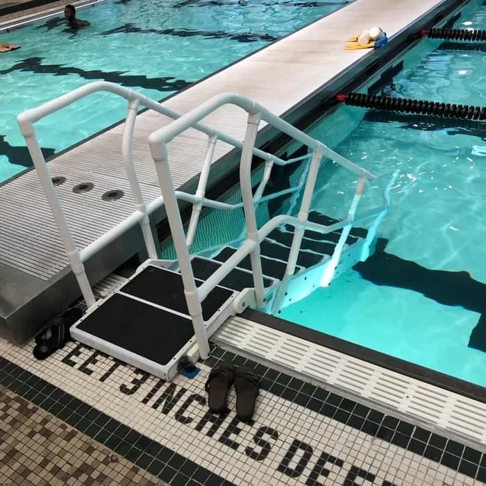 Pool safety equipment staged at the edge of a lap pool