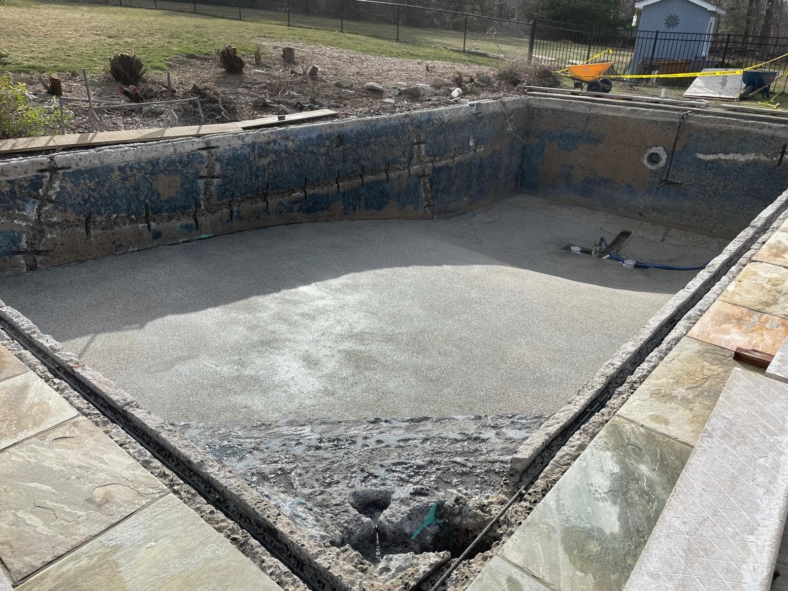 Drained pool shell stripped to bare structure ahead of a new finish coat