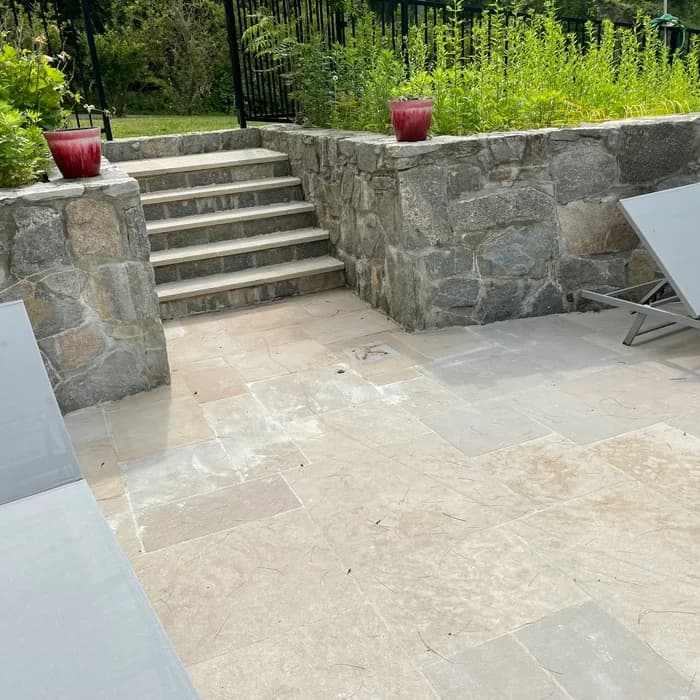 Existing pool refinished with a fresh fiberglass coating and stone-step surround